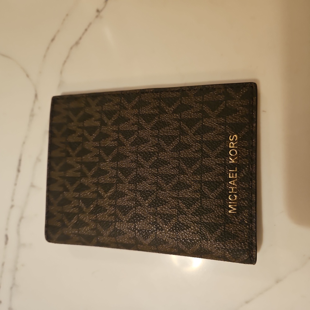 Michael Kors passport wallet. Brand new. Never used.